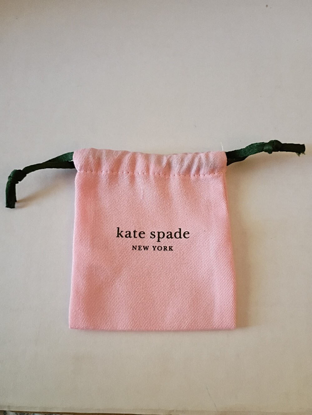 light pink Kate Spade New York jewelry drawstring pouch
